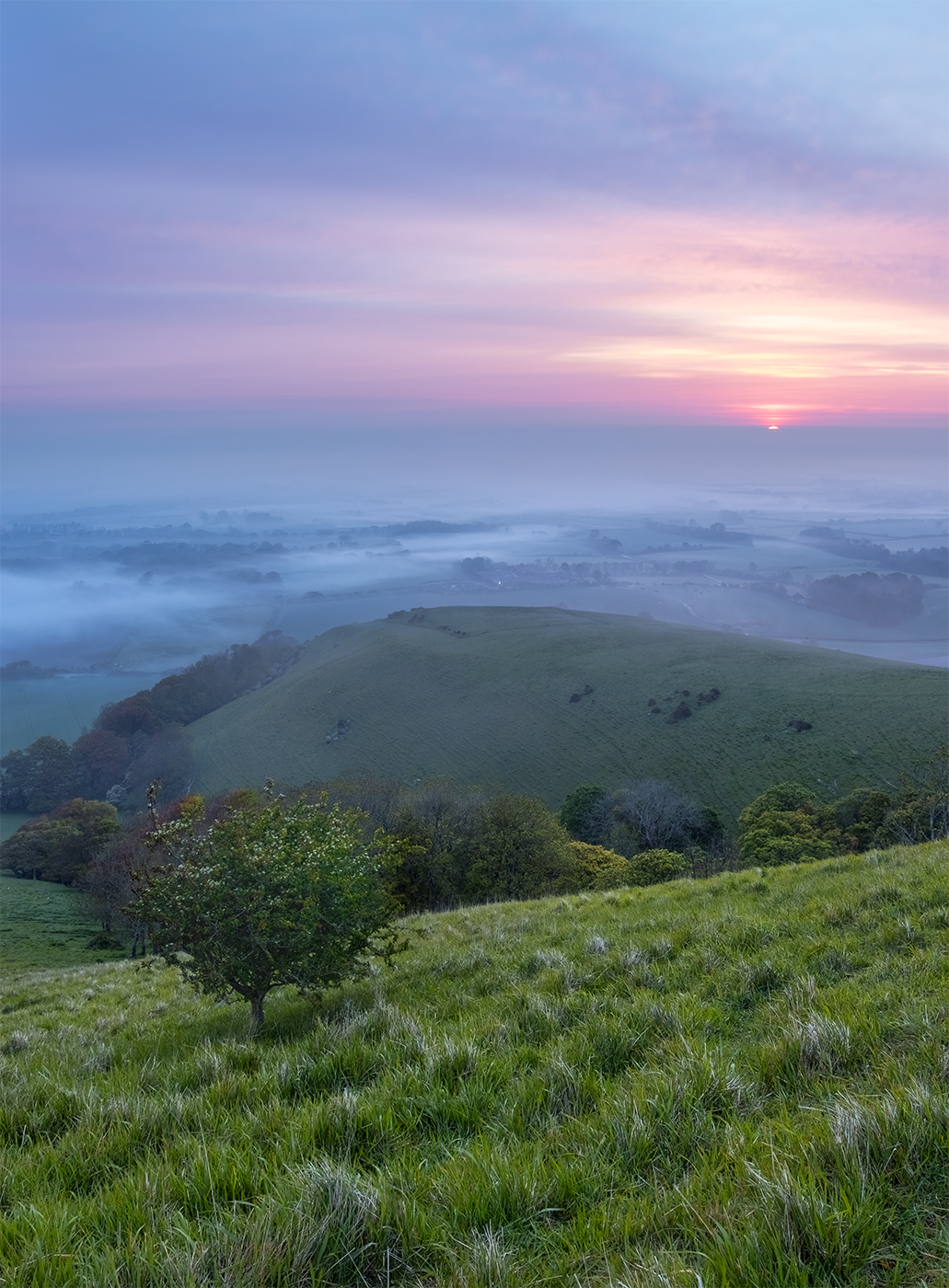 Photographic print of a sunrise over a morning mist inversion in the English countryside.