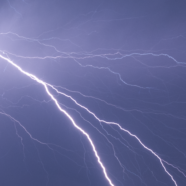 Closeup of forked lightning containing many colourful branches