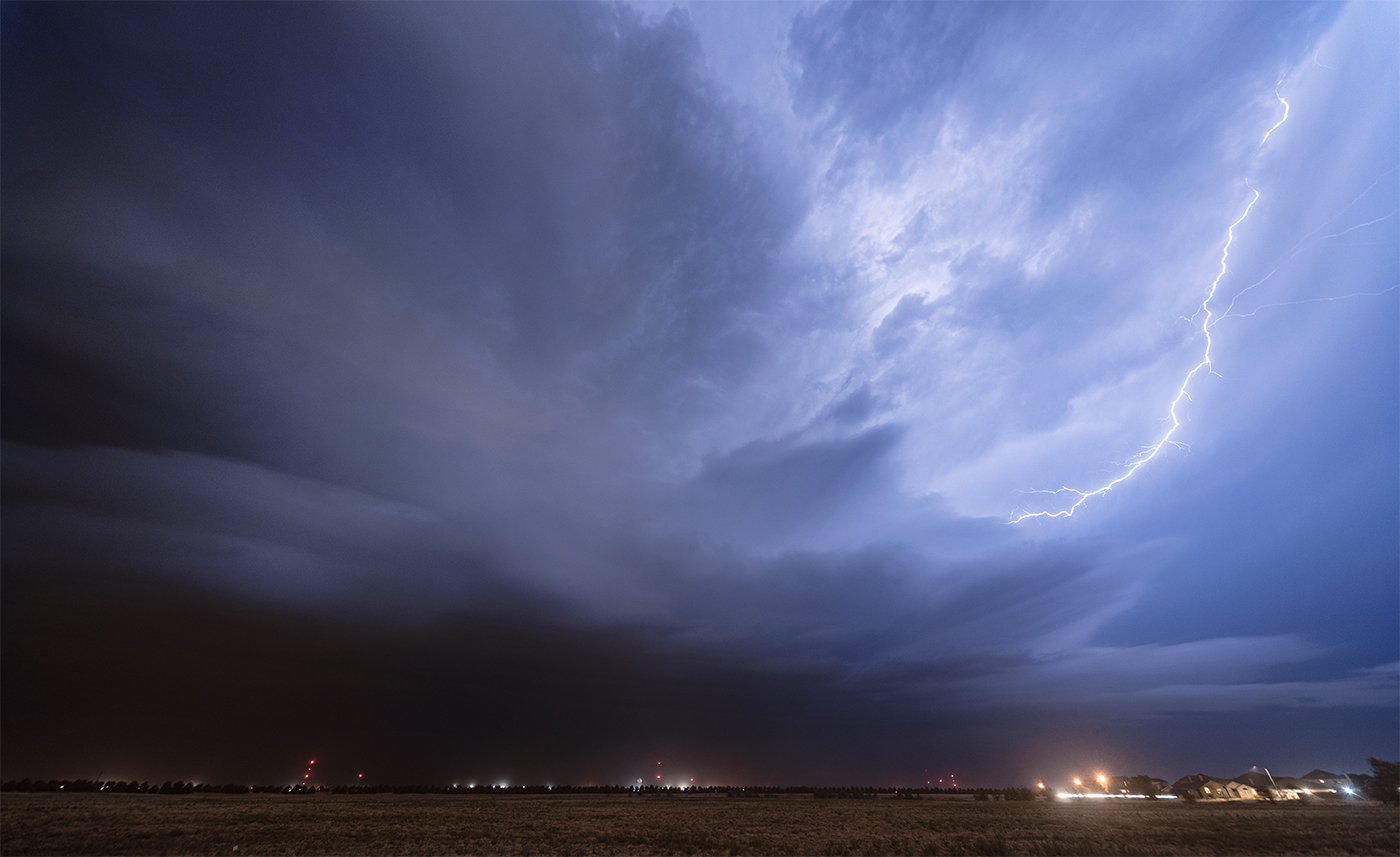 A lightning bolt strikes out of the anvil and into the updraft of the Levelland supercell in Texas.