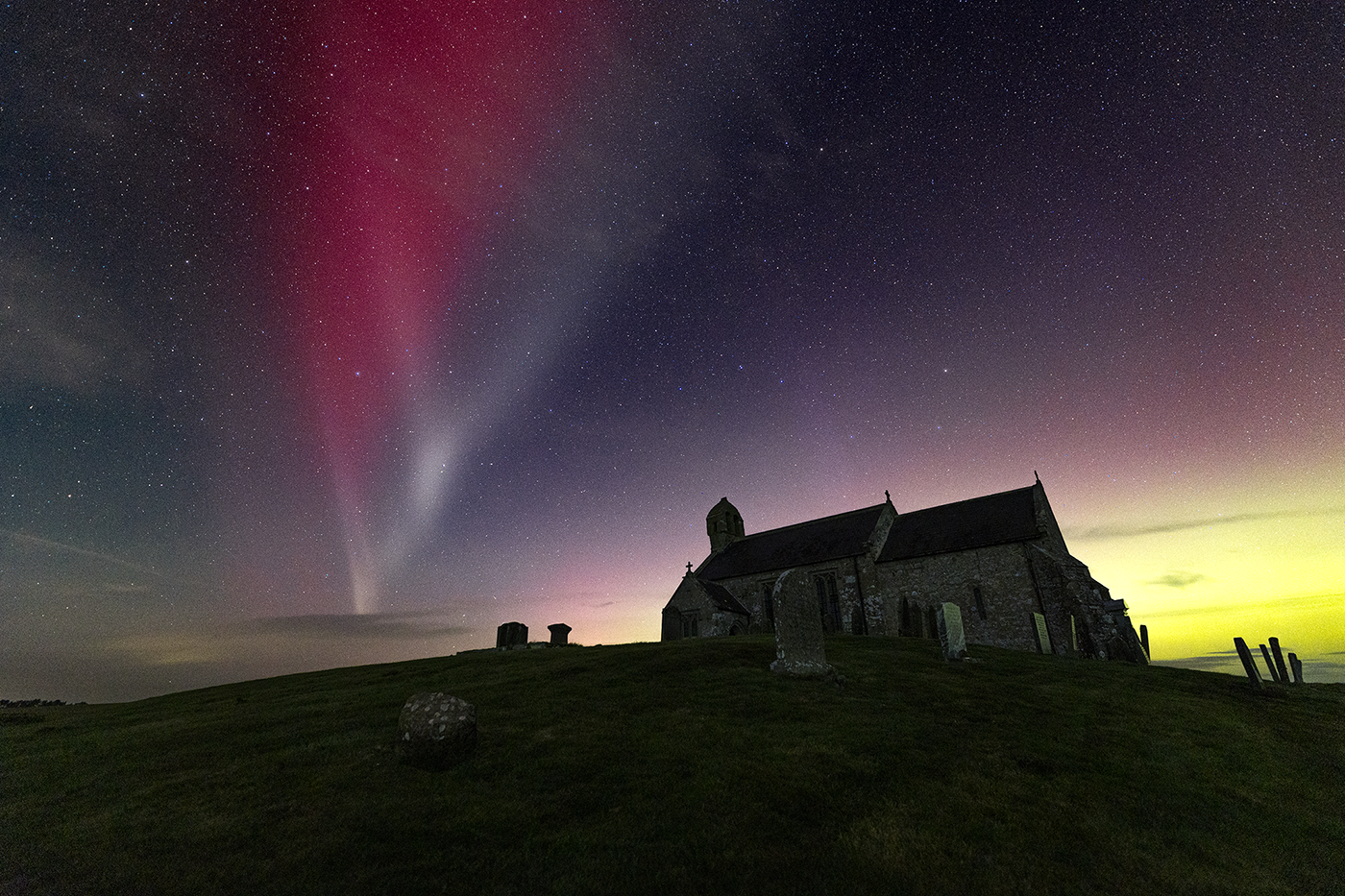 A STEVE formation above an 11th century medieval church in Northumberland.